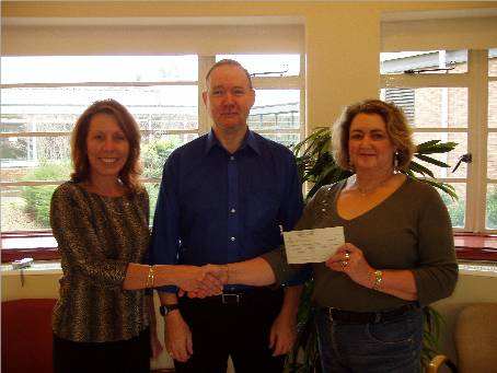 from left to right Desiree Zimmermann of the Harefield Hospital Fundraising Dept., W.Bro. Peter Edwards and Mrs Christine Edwards